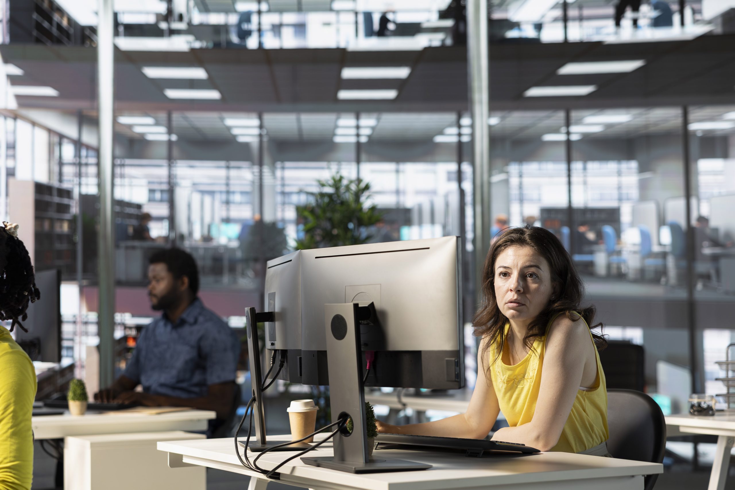 IT employees in office working at computer desks, testing and deploying programs and systems. Programmer and developers checking code on desktop PCs, solving tasks in workspace