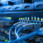 Network cables in a data center connect servers with LED lights for fast and efficient data communication